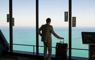 America loses if it does not have an effective Startup Visa... image of a man standing in airport with luggage