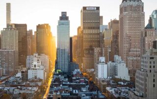Immigrants have started nearly half of America’s 50 top venture-funded companies, image showing skyscrapers with sunrise between in downtown Chicago, United States of America